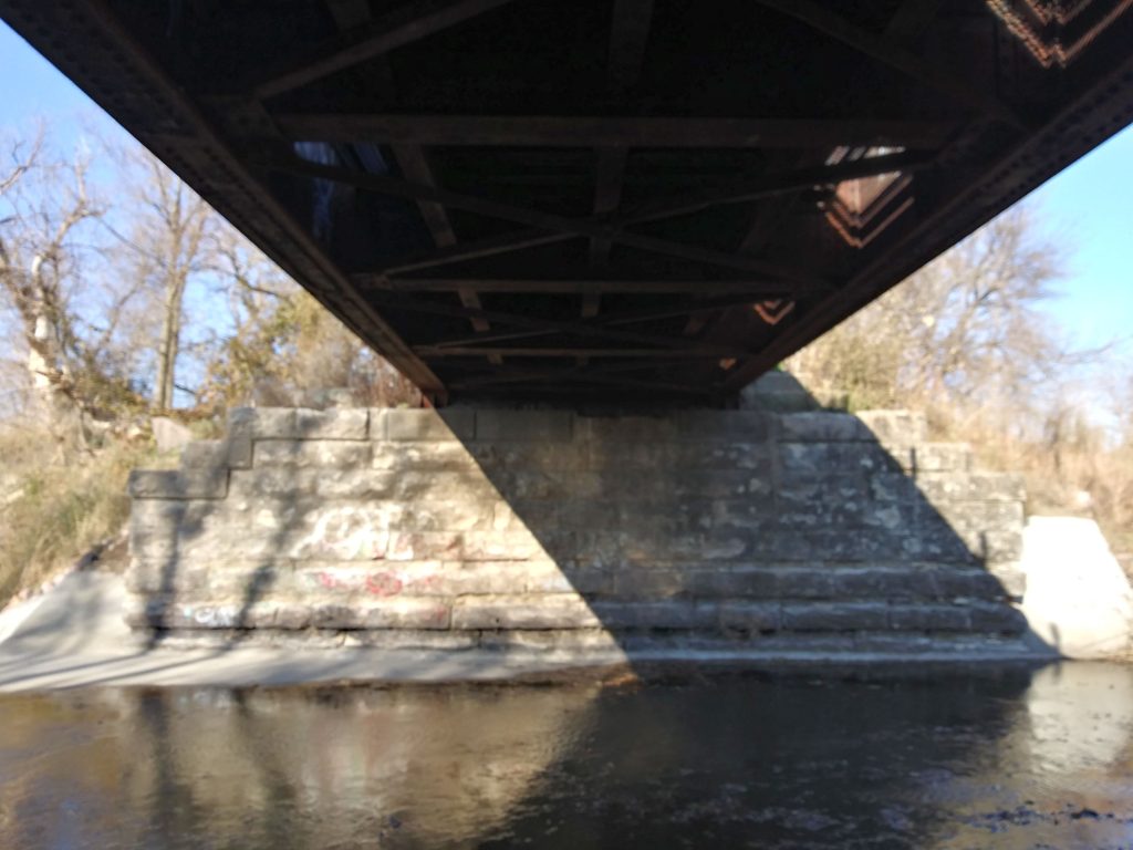 Under side of bridge over creek.